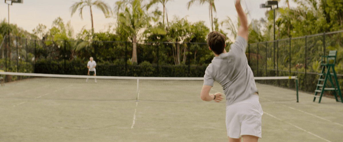 a man serving in tennis in Apples Never Fall